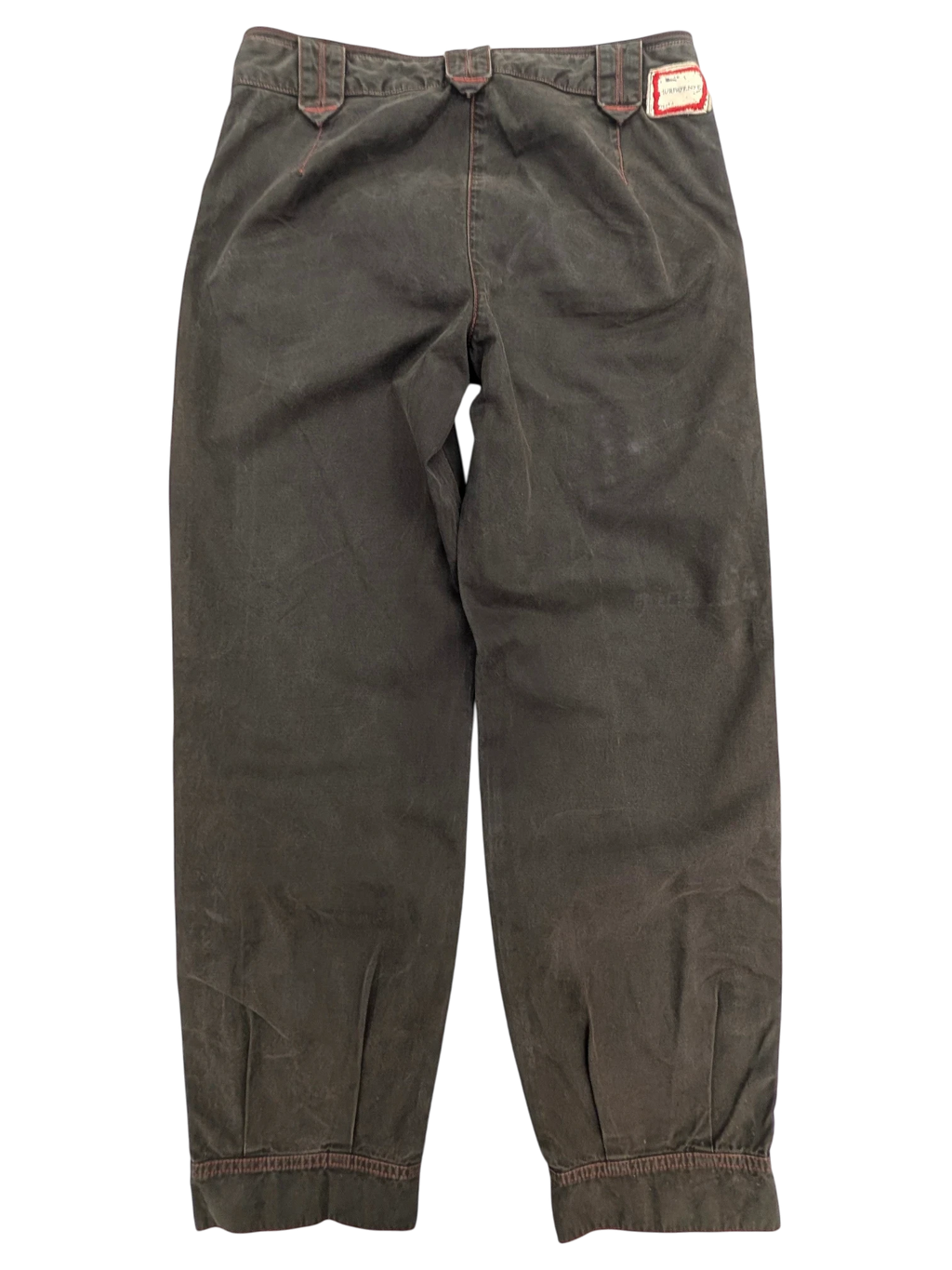 JAKE & IPI Murphy and Nye cargo pants in dark olive green cotton with red stitching detail and adjustable waist tabs.