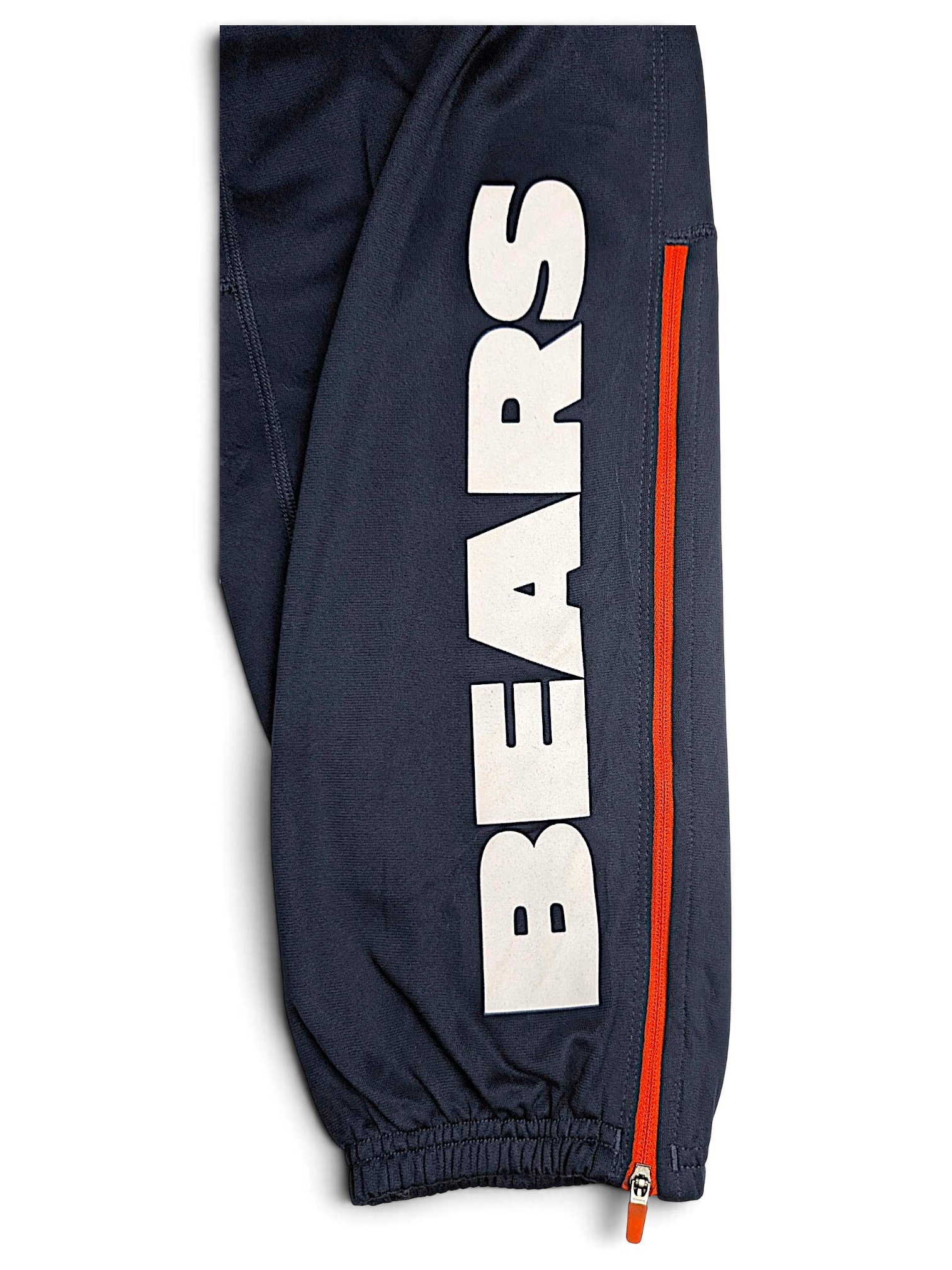 JAKE & IPI Nike Chicago Bears navy blue Dri-FIT track pants with orange zipper detail and white Bears lettering
