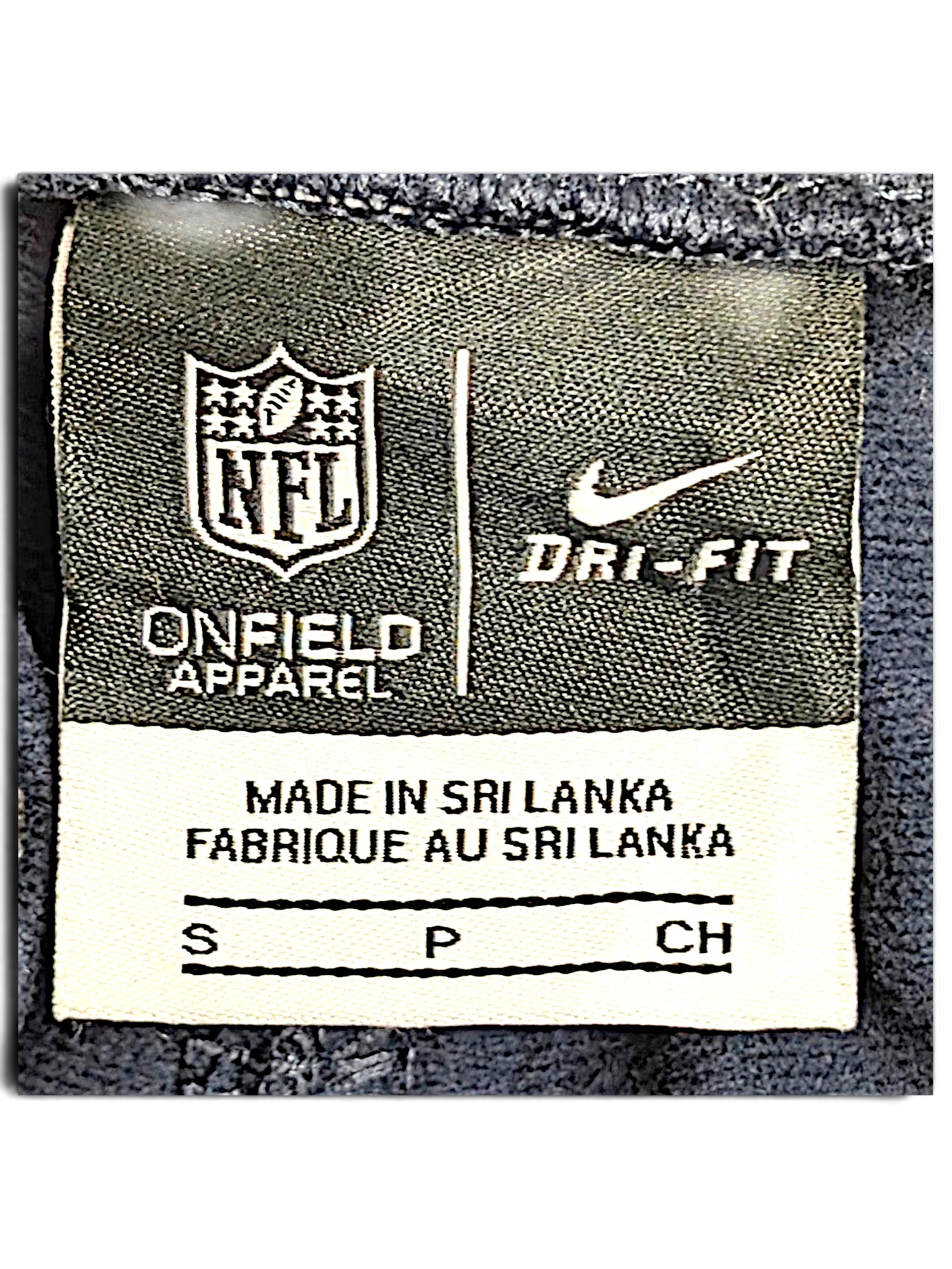 JAKE & IPI Nike NFL Dri-FIT track pants size S clothing label showing branding and origin