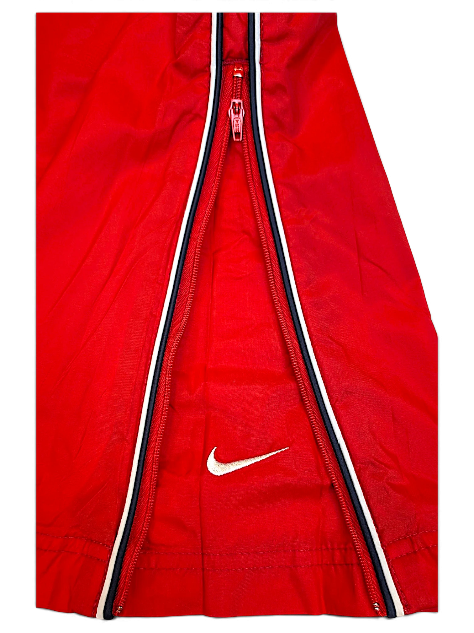 JAKE & IPI Nike red track pants featuring a black and white side stripe with a white embroidered Swoosh logo
