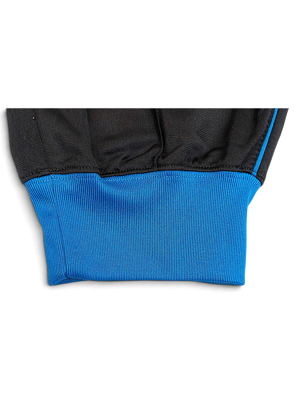 JAKE & IPI Nike grey and black track pants featuring a vibrant blue ribbed ankle cuff and contrast piping detail.