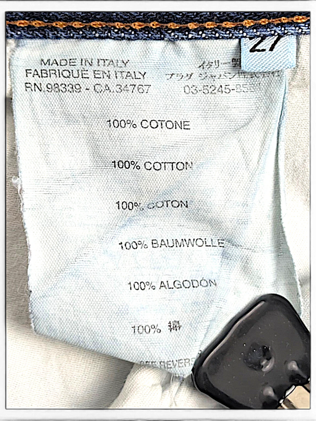 JAKE & IPI Prada blue jeans care label showing 100% cotton composition and Made in Italy origin