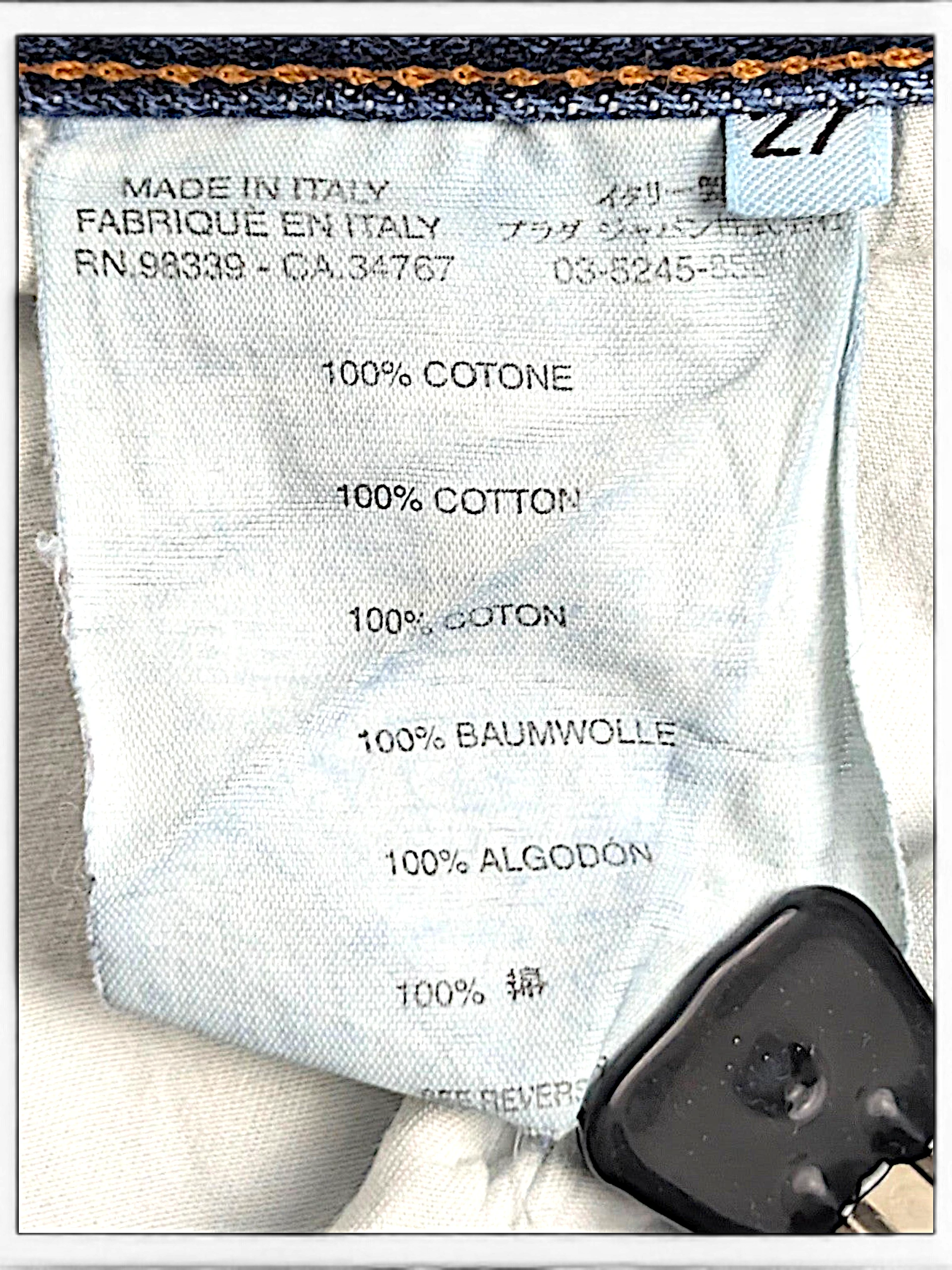 JAKE & IPI Prada blue jeans care label showing 100% cotton composition and Made in Italy origin
