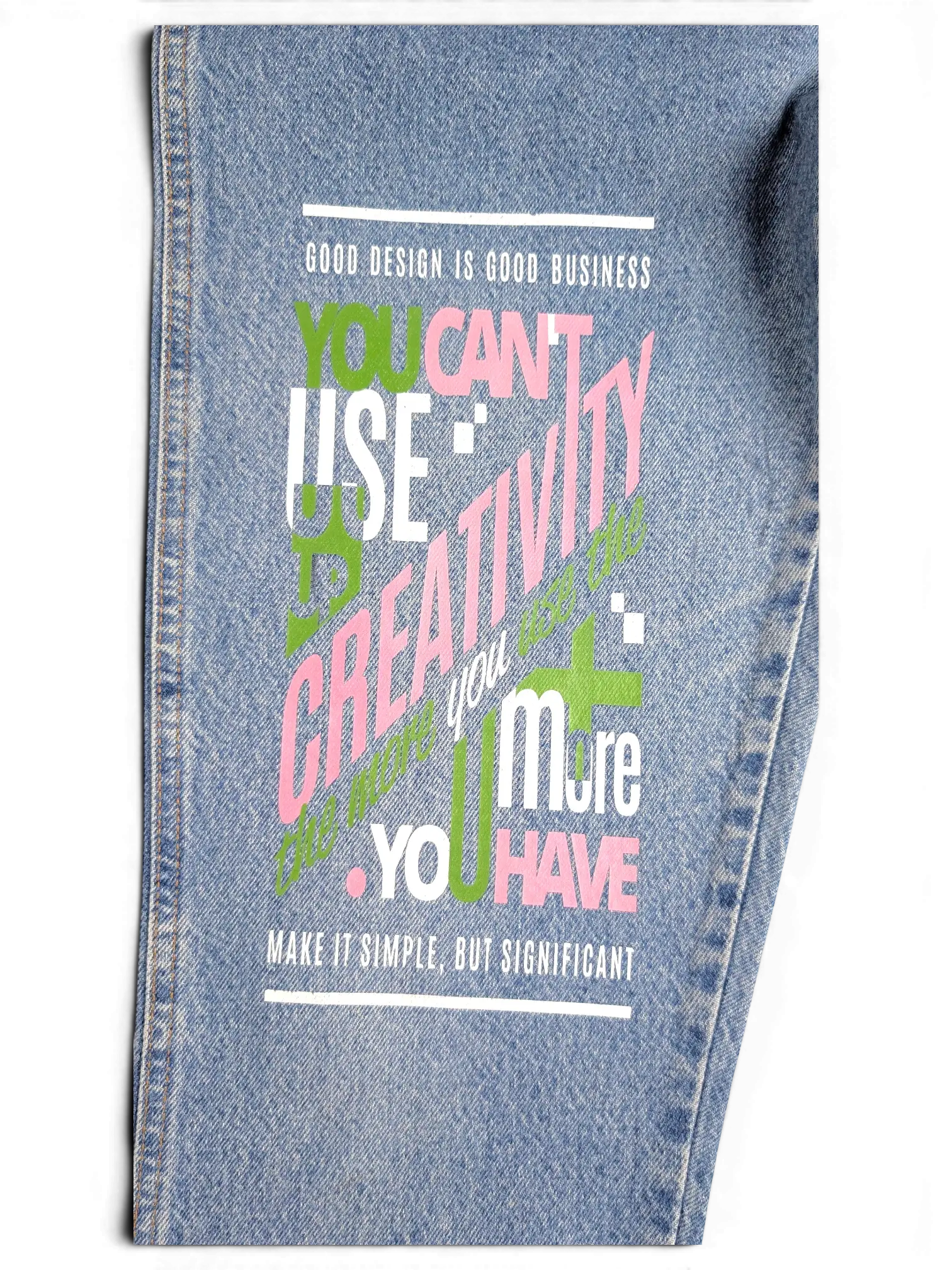 JAKE & IPI blue denim jeans featuring a large graphic print with pink and green typography and motivational quotes.