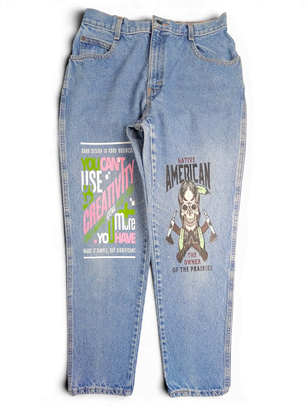 JAKE & IPI blue denim jeans with graphic prints on both legs featuring skull and typography designs.