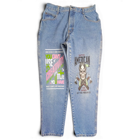 JAKE & IPI blue denim jeans with graphic prints on both legs featuring skull and typography designs.