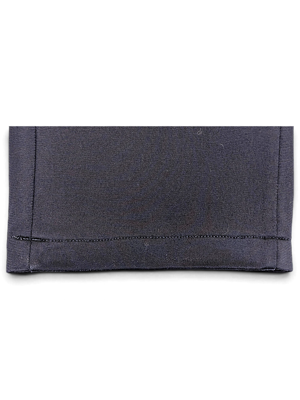 Close-up of the navy hem on JAKE & IPI pre-owned Puma track pants showing straight-leg stitching detail.