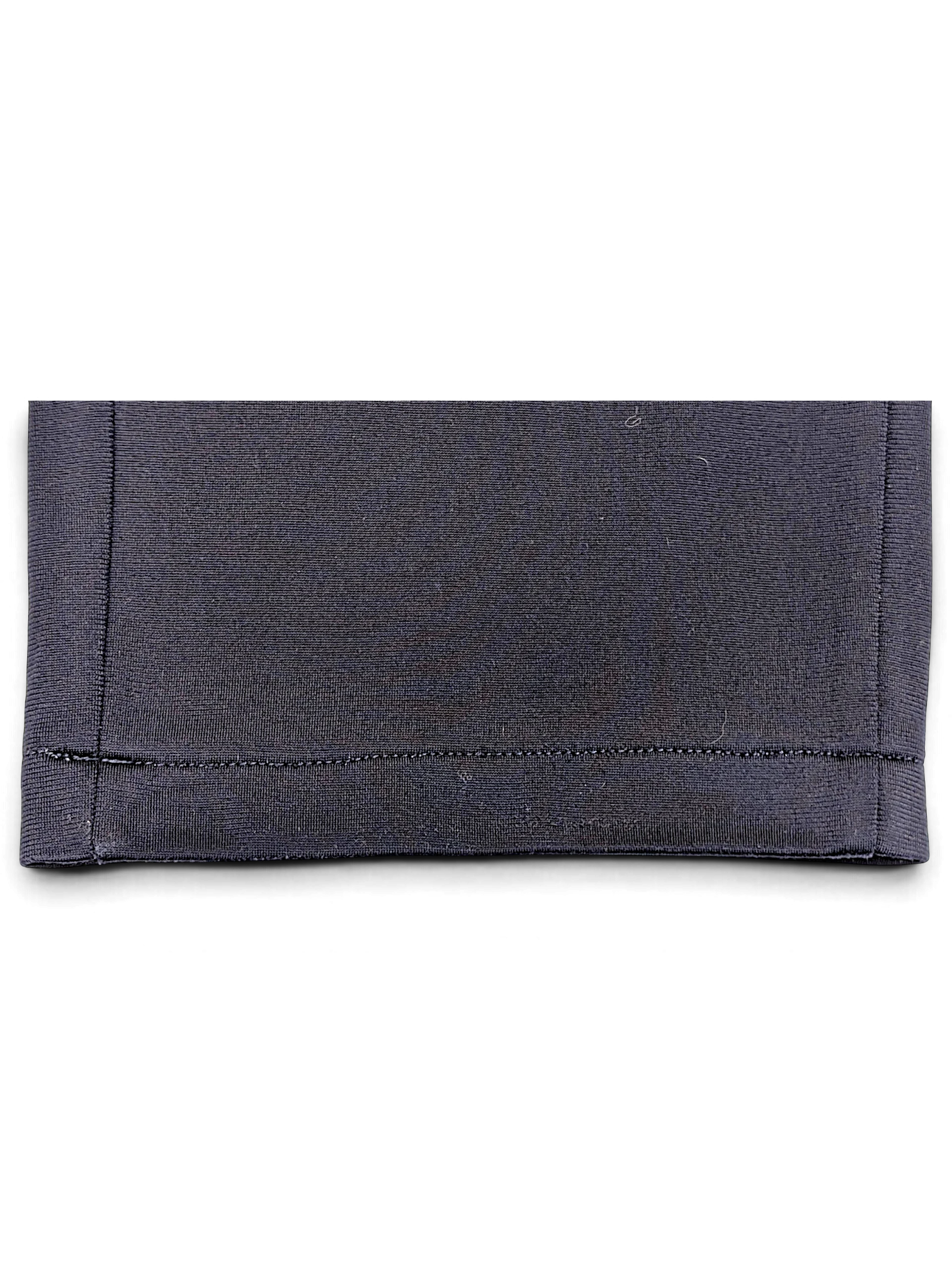 Close-up of the navy hem on JAKE & IPI pre-owned Puma track pants showing straight-leg stitching detail.