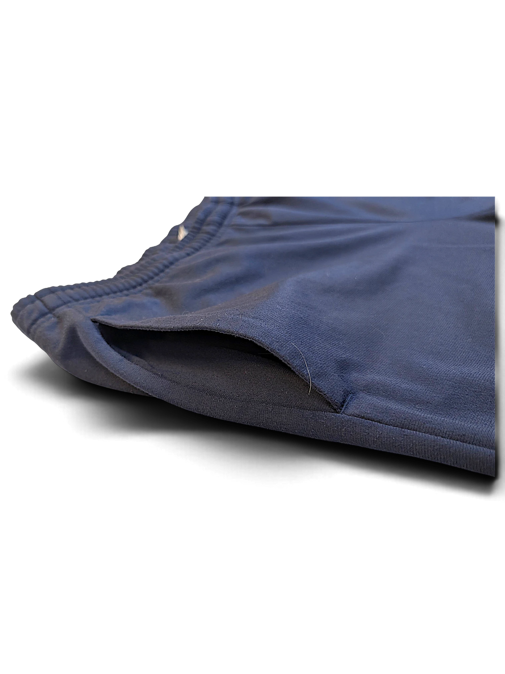 JAKE & IPI pre-owned navy Puma track pants featuring a close-up of the side pocket detail.