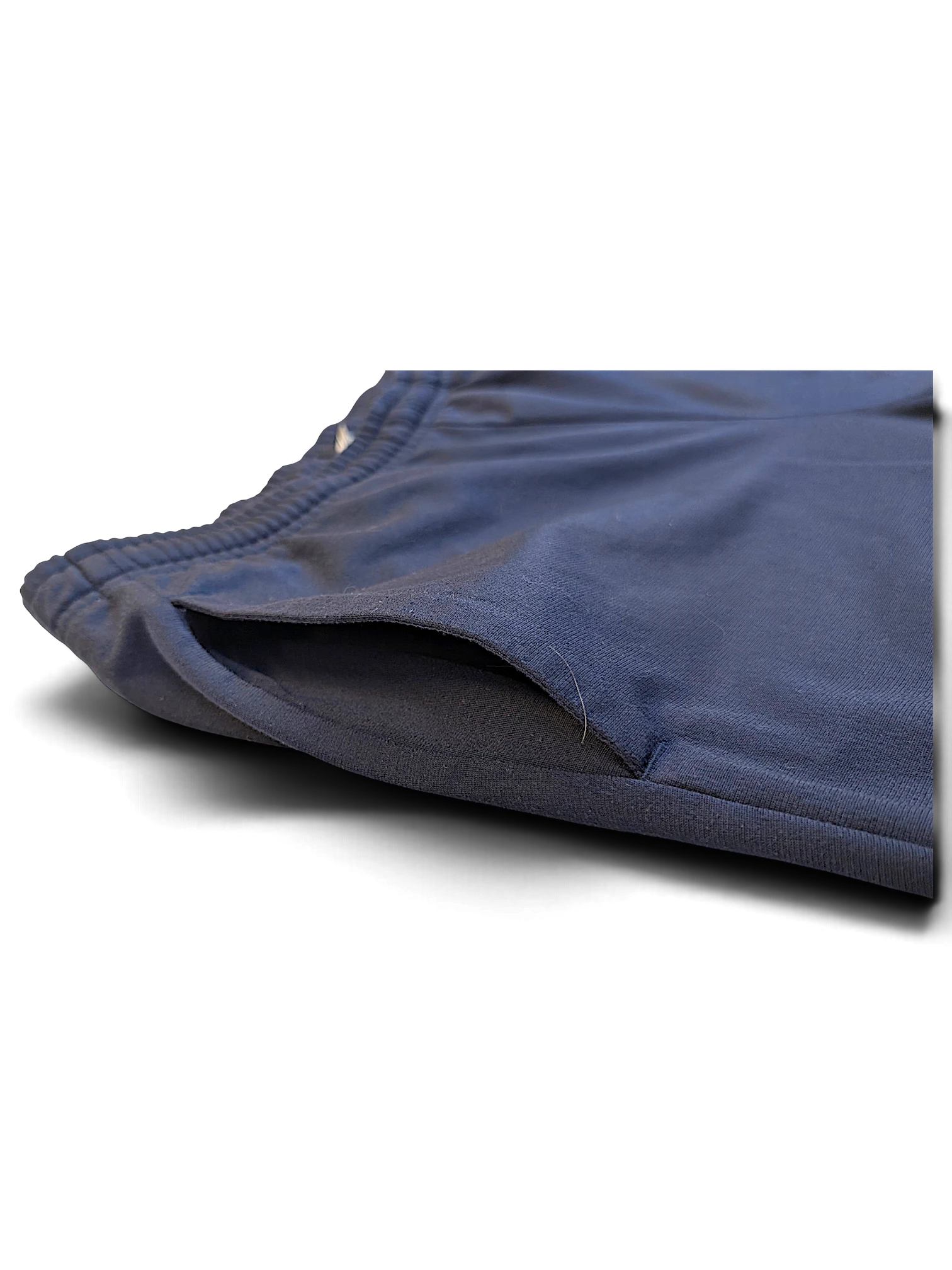 JAKE & IPI pre-owned navy Puma track pants featuring a close-up of the side pocket detail.