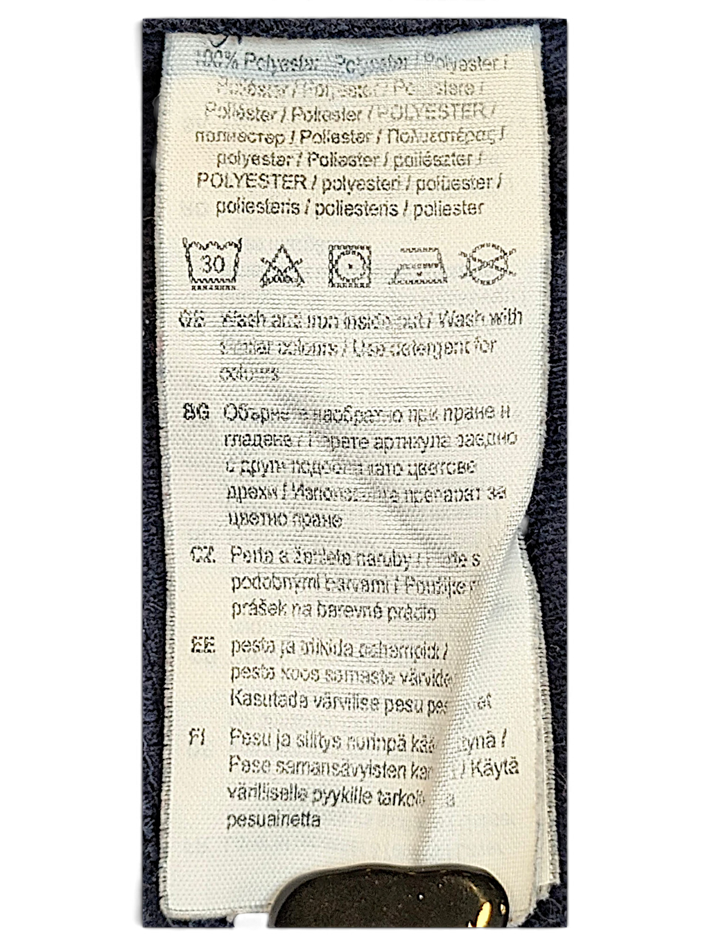 JAKE & IPI Puma track pants care label showing 100 percent polyester composition and washing instructions
