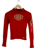 JAKE & IPI red ribbed knit long sleeve top with gold monogram, script logo, and butterfly detail. Made in Italy.