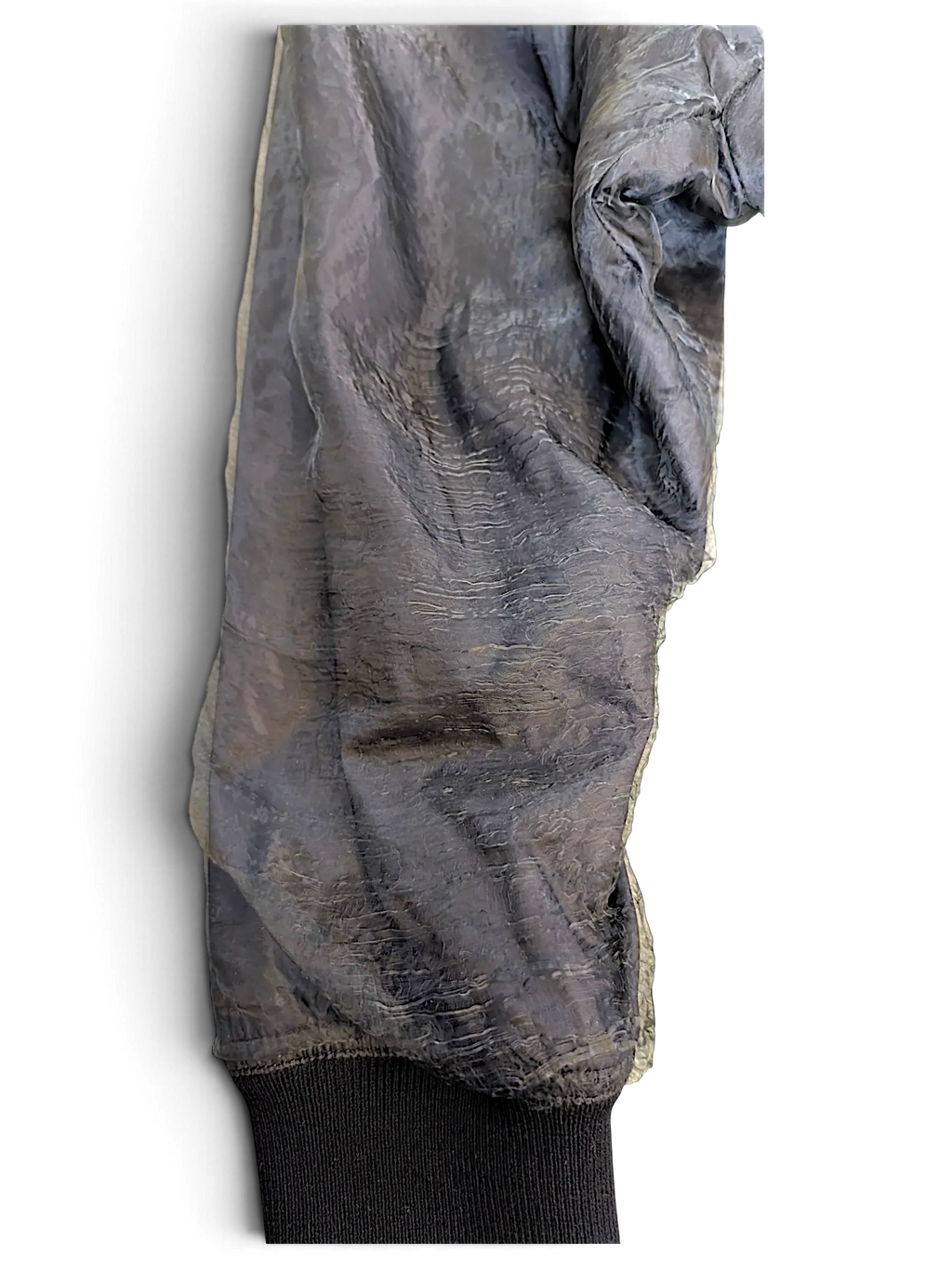 JAKE & IPI Rick Owens bomber jacket sleeve in a sheer, crinkled dark grey fabric with a ribbed black cuff.