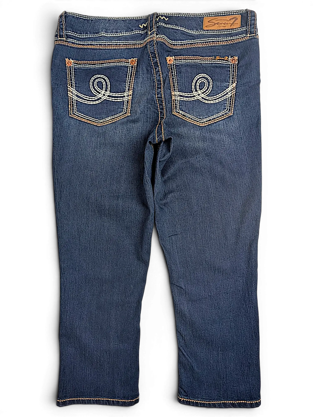 JAKE & IPI Seven7 dark wash denim capri jeans with decorative white swirl stitching on back pockets