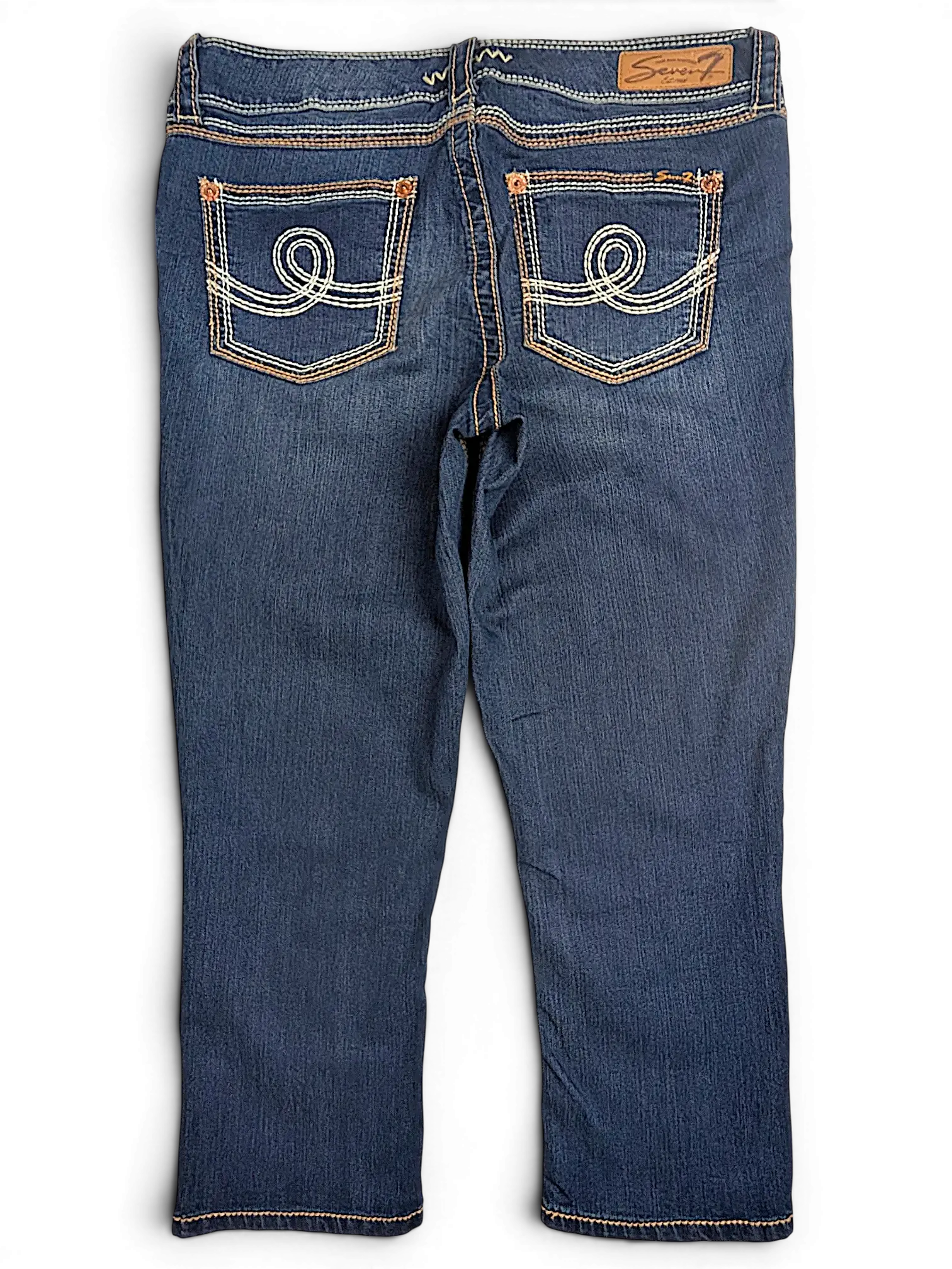 JAKE & IPI Seven7 dark wash denim capri jeans with decorative white swirl stitching on back pockets