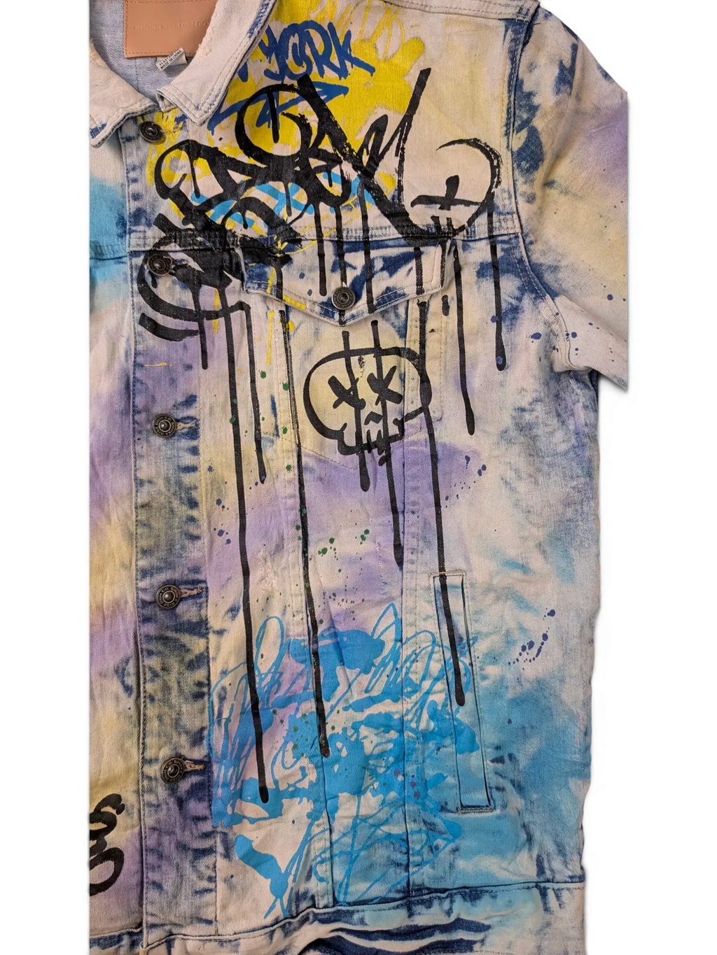 JAKE & IPI Smoke Rise denim jacket with graffiti-style paint splatters in yellow, blue, purple, and black.