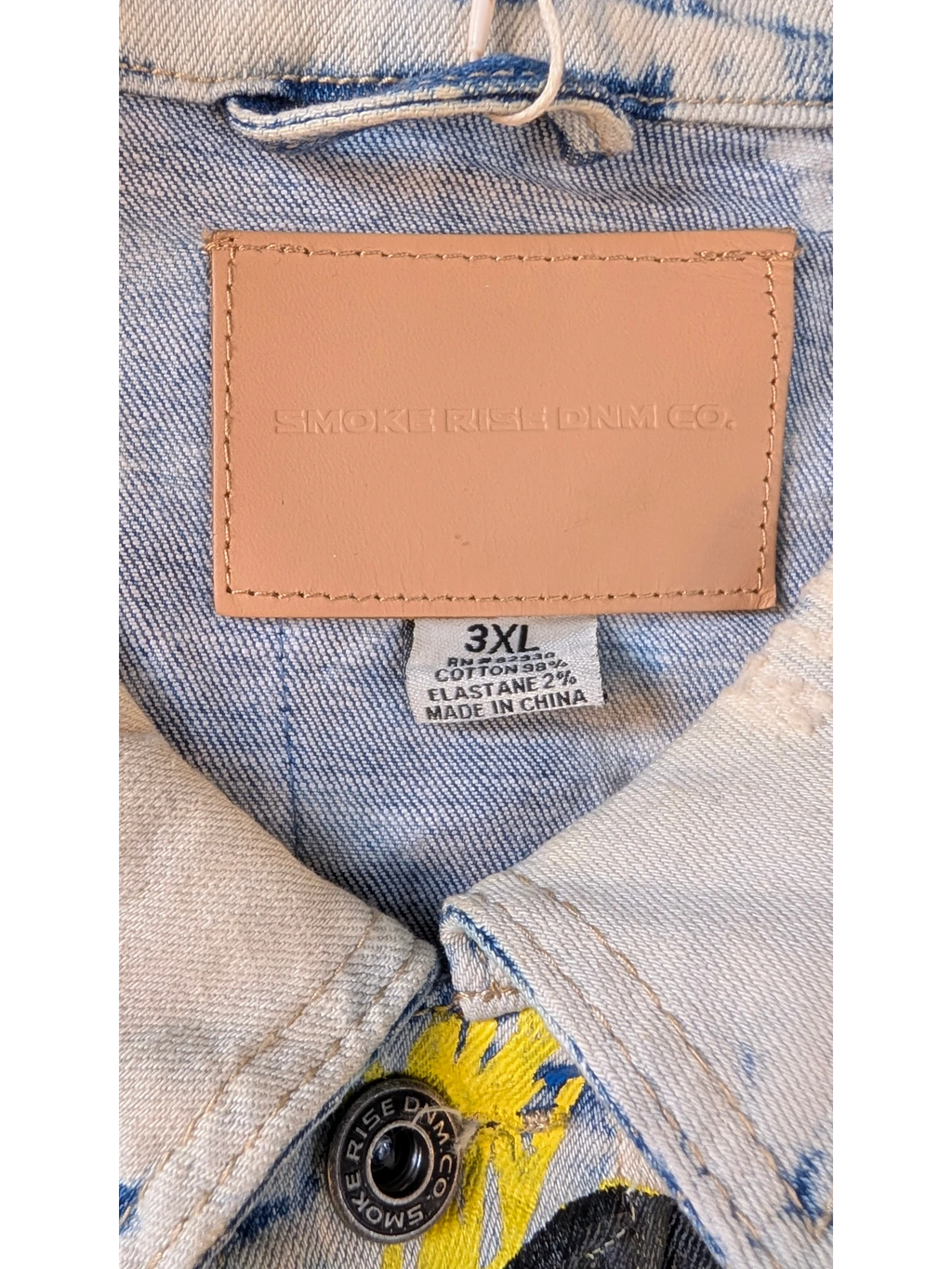 JAKE & IPI Smoke Rise denim jacket in light wash blue with yellow graphic print and leather logo patch. Cotton blend.