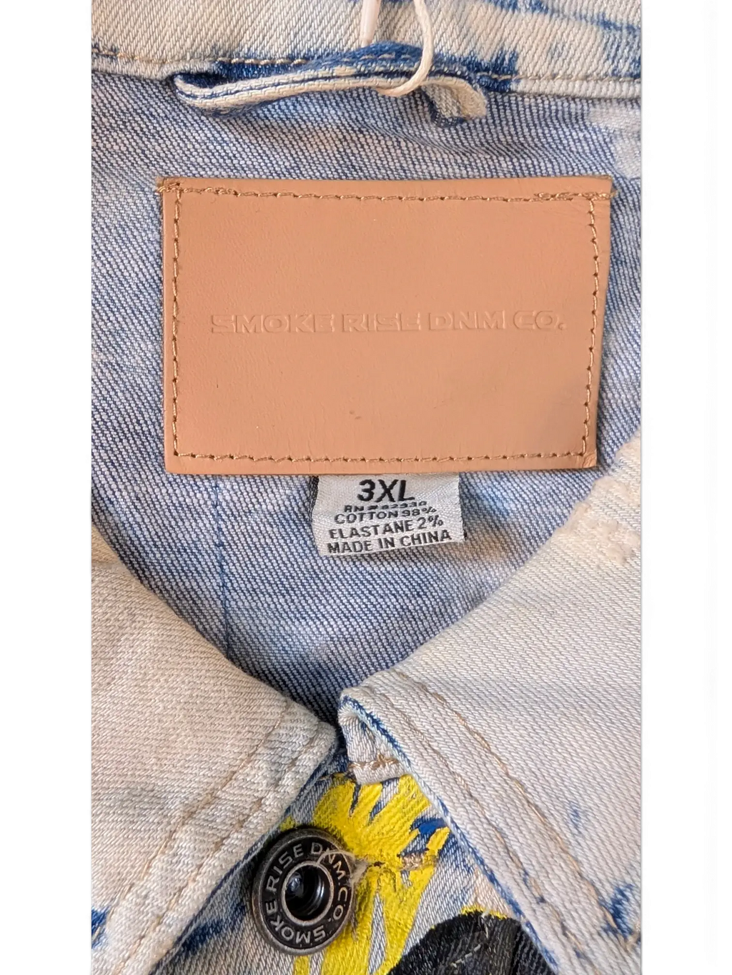 JAKE & IPI Smoke Rise denim jacket in light wash blue with yellow graphic print and leather logo patch. Cotton blend.