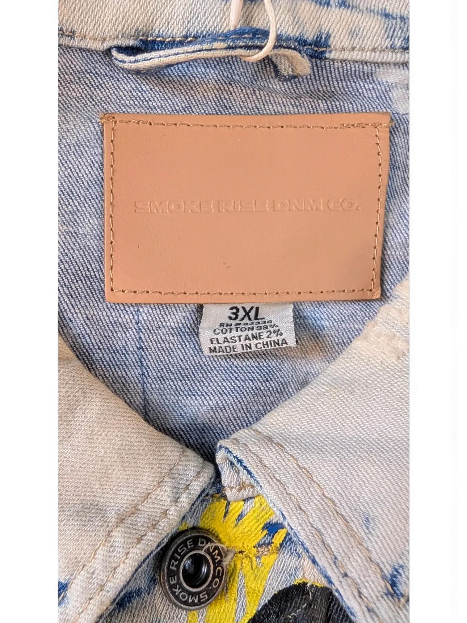 JAKE & IPI Smoke Rise denim jacket in light wash blue with yellow graphic print and leather logo patch. Cotton blend.