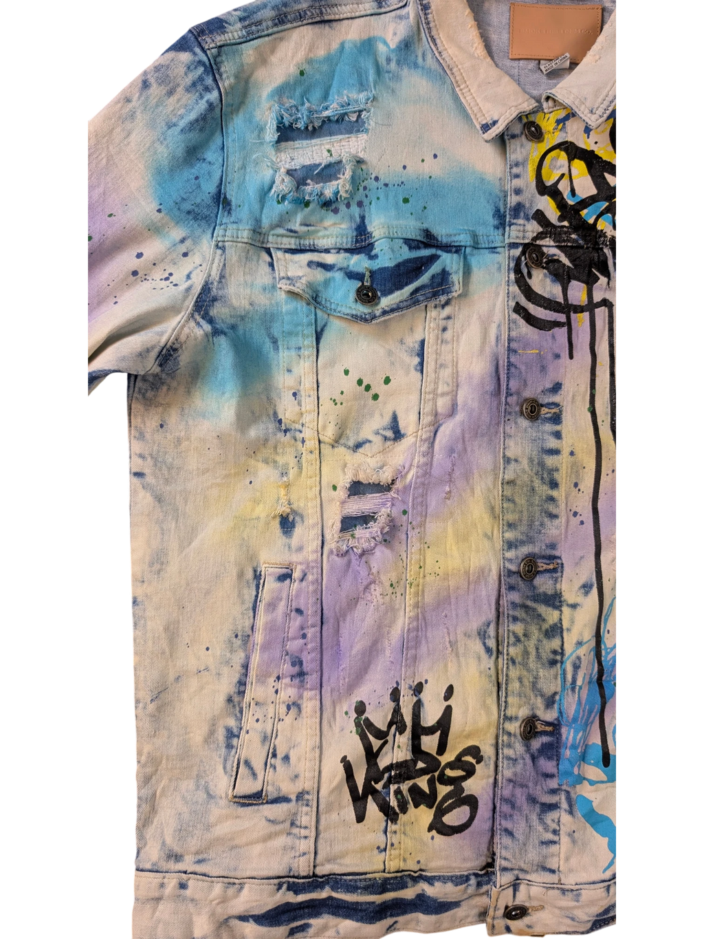 JAKE & IPI Smoke Rise denim jacket with tie-dye wash, distressed details, and graffiti art.