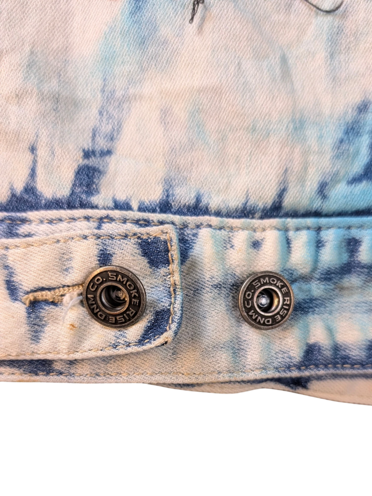 JAKE & IPI Smoke Rise denim jacket with blue and white tie-dye wash and branded metal buttons.
