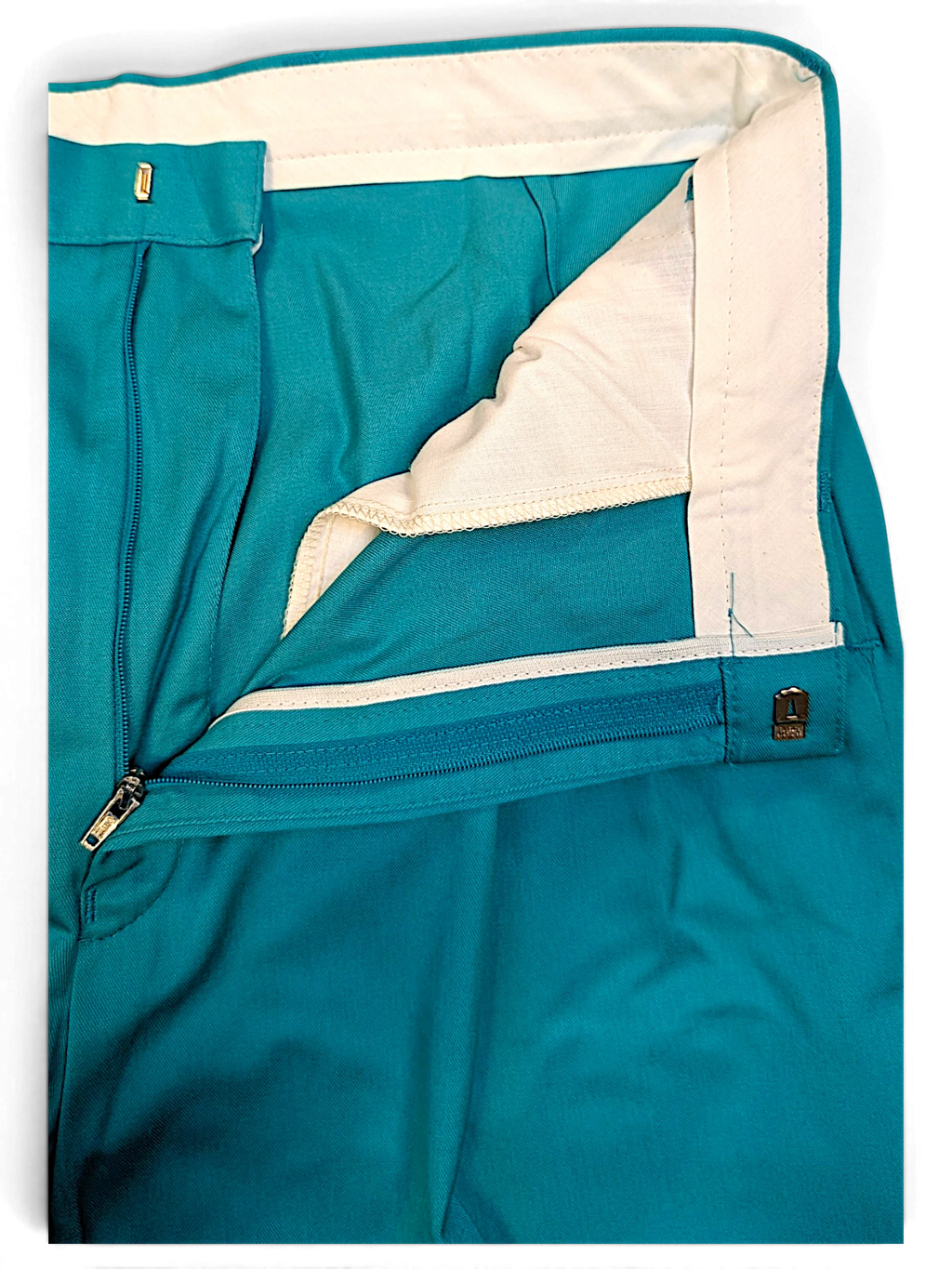 JAKE & IPI St Michael vintage green pleated trousers showing the interior waistband, zipper fly, and fabric texture.
