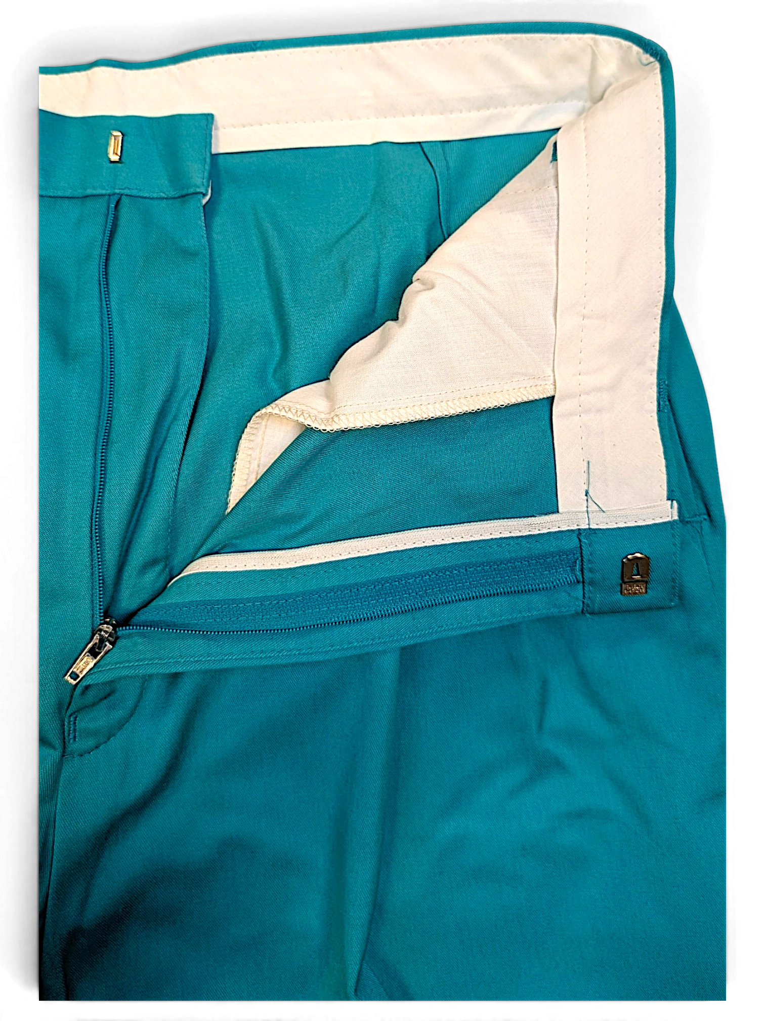 JAKE & IPI St Michael vintage green pleated trousers showing the interior waistband, zipper fly, and fabric texture.