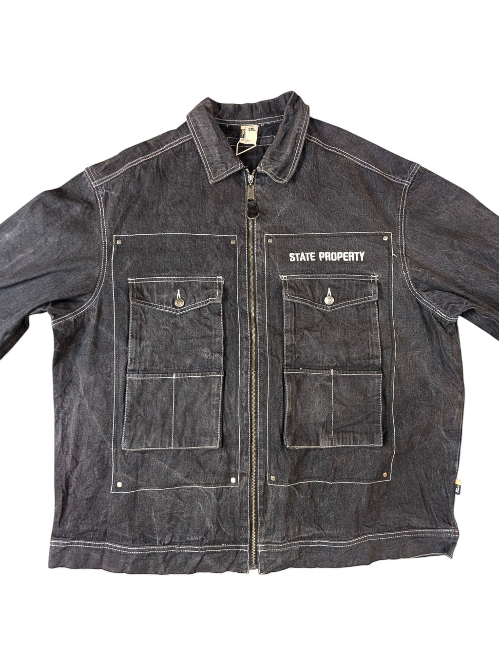 JAKE & IPI State Property dark wash denim jacket with white contrast stitching, zip-up front, and four chest pockets.