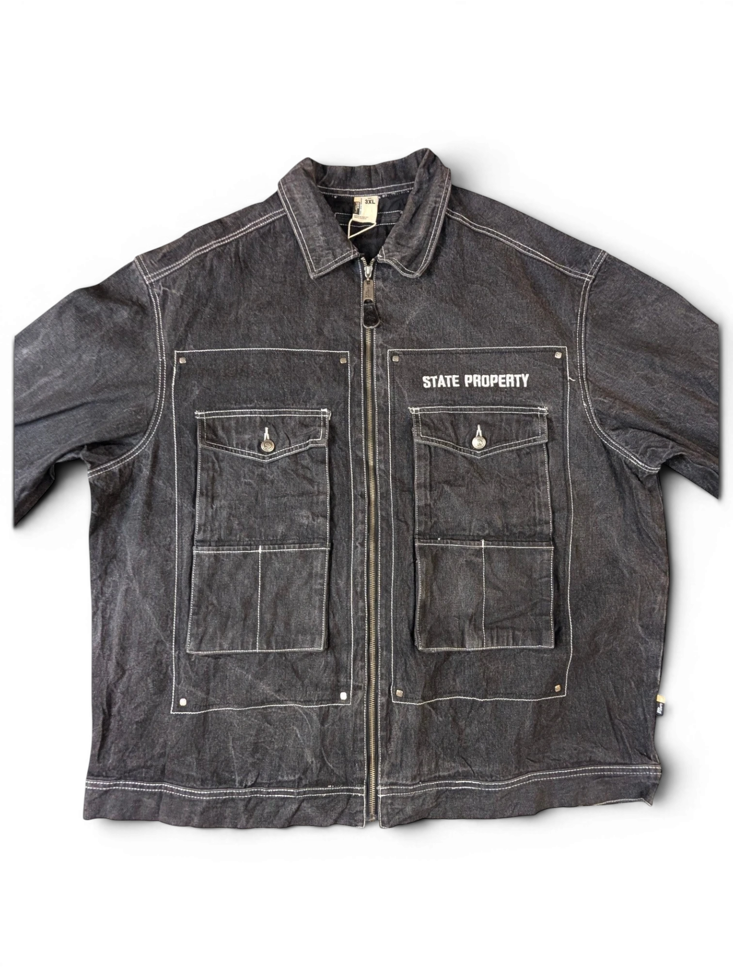 JAKE & IPI State Property dark wash denim jacket with white contrast stitching, zip-up front, and four chest pockets.