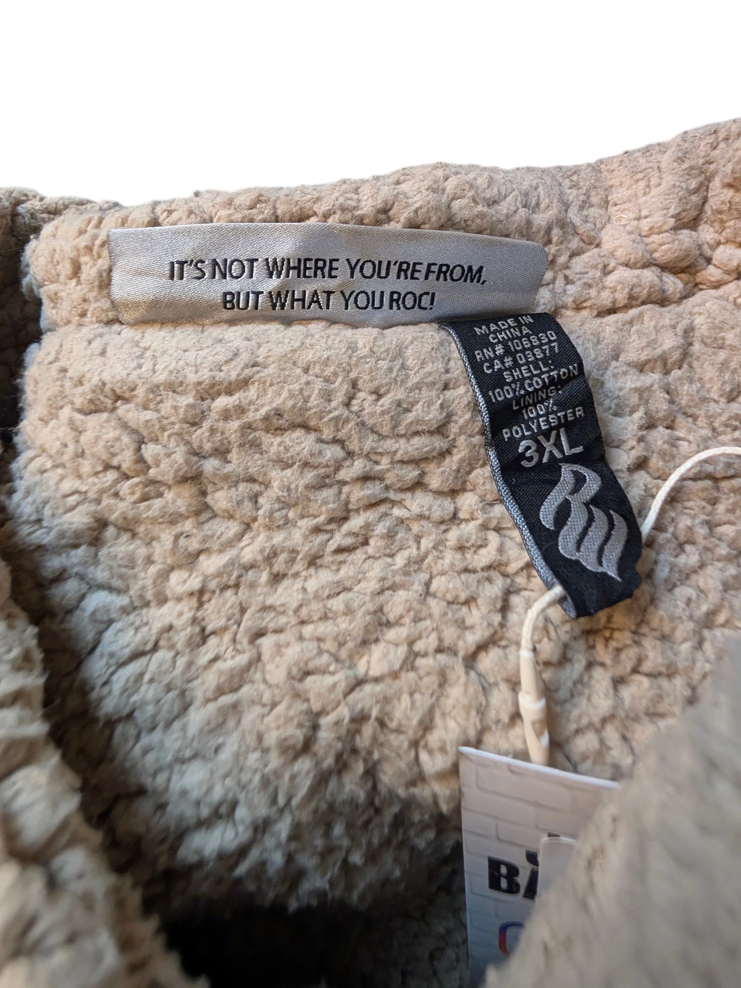 JAKE & IPI tan sherpa lined Rocawear denim jacket with "IT'S NOT WHERE YOU'RE FROM, BUT WHAT YOU ROC!" tag.