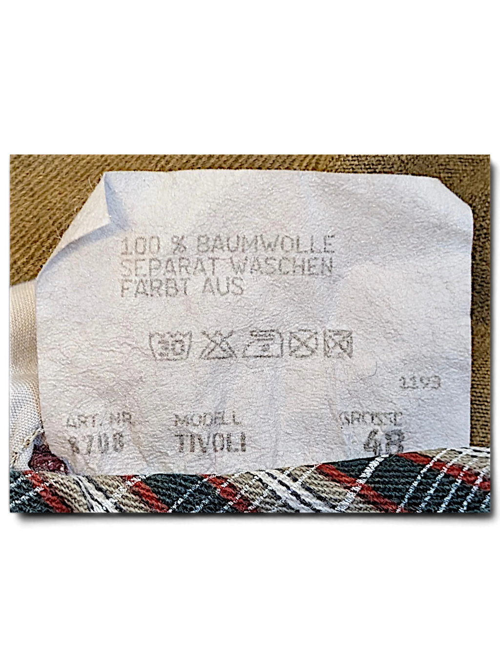 JAKE & IPI Tivoli trousers garment care label showing 100 percent cotton composition and size 48