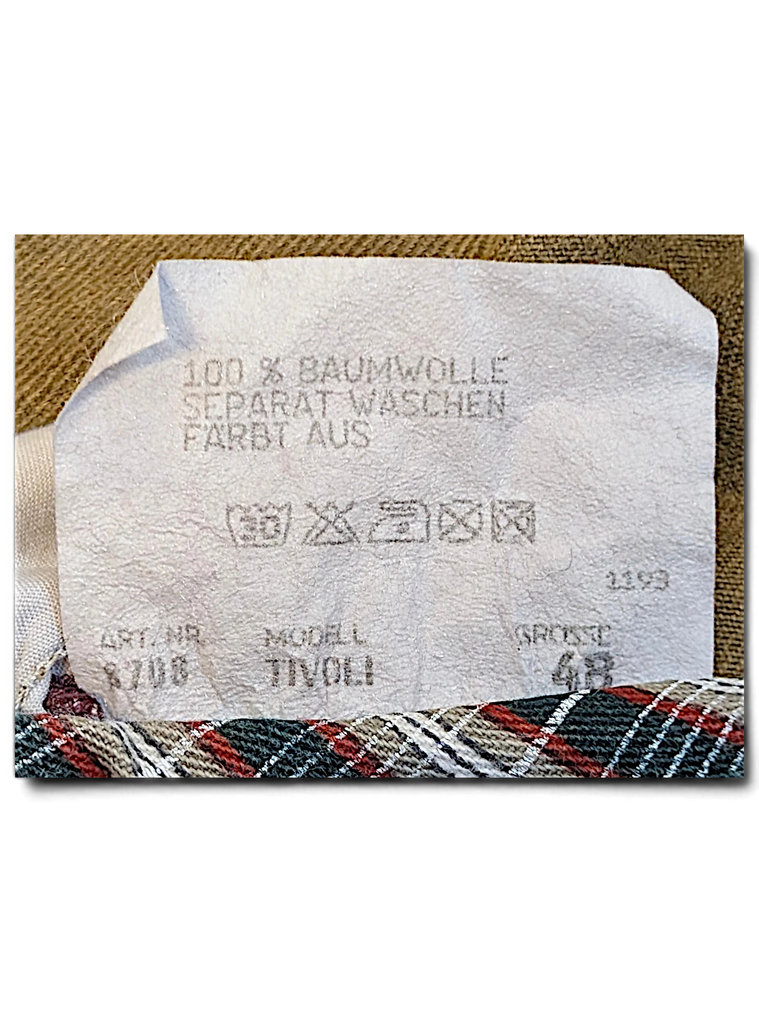 JAKE & IPI Tivoli trousers garment care label showing 100 percent cotton composition and size 48