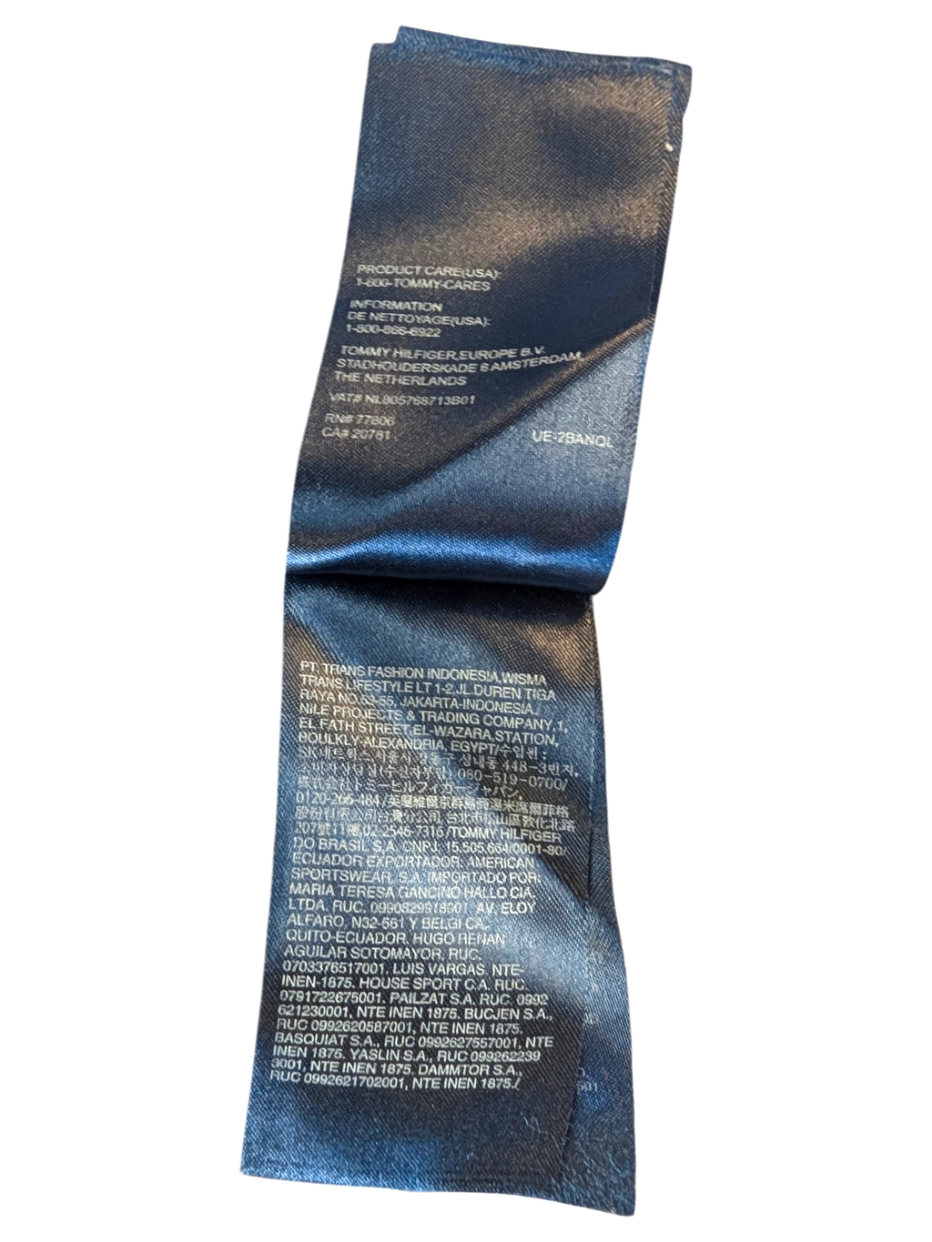 JAKE & IPI Tommy Hilfiger Hawaiian shirt care label with blue floral fabric background