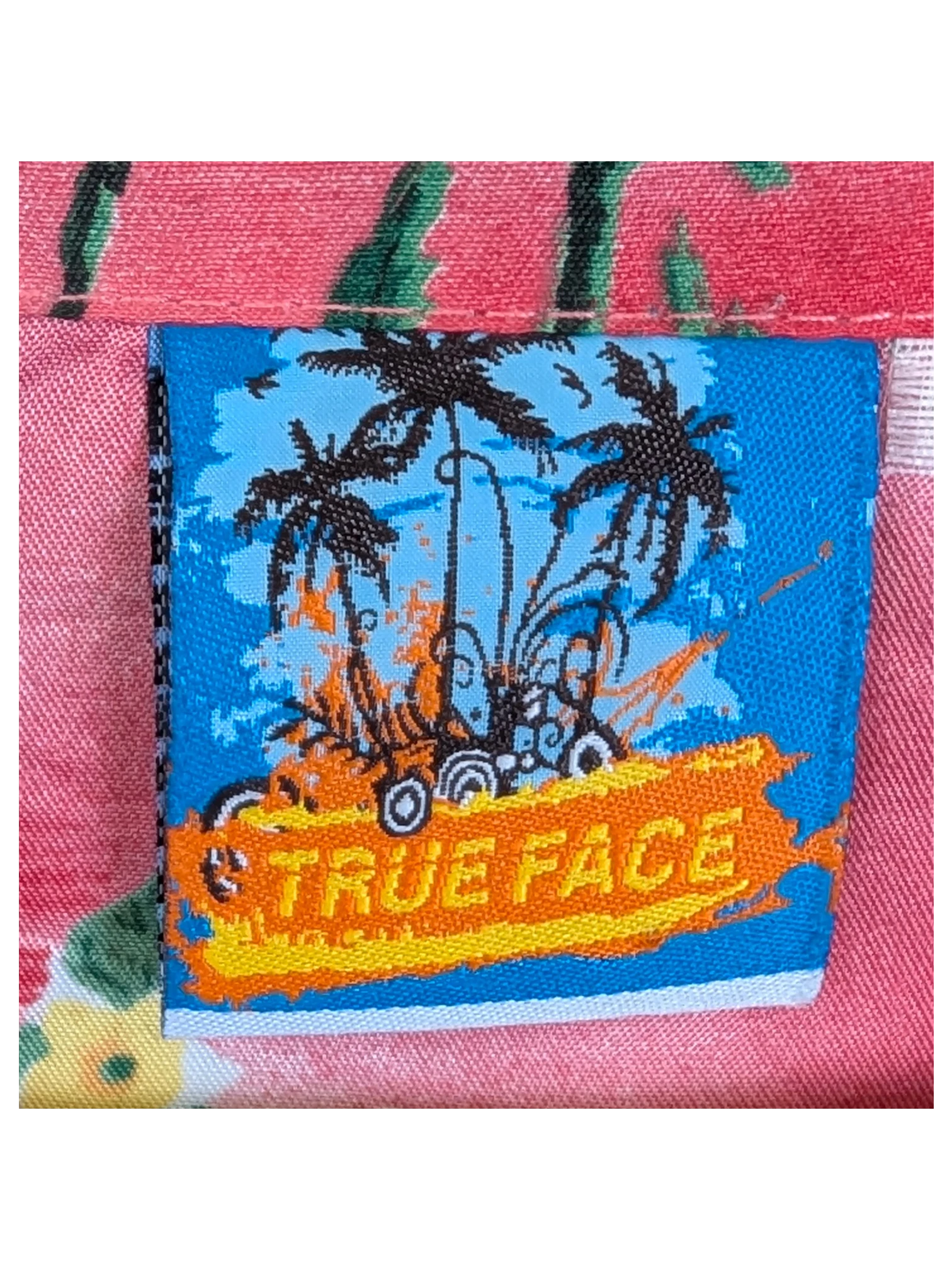 JAKE & IPI True Face Hawaiian shirt featuring a pink tropical palm tree print and a branded blue neck label