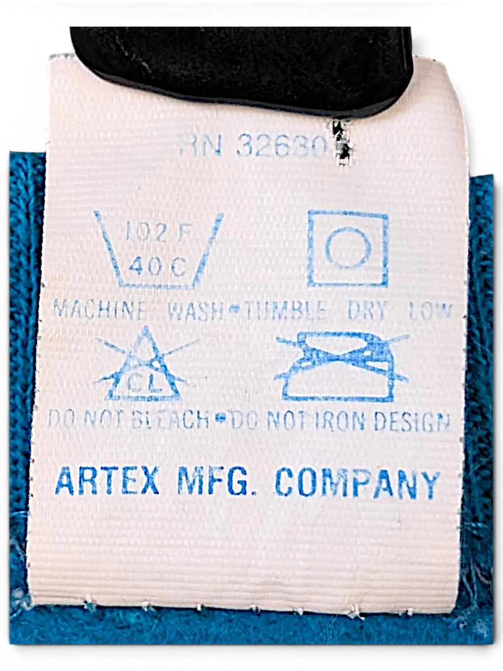 JAKE & IPI vintage Artex Mfg. Company clothing care label with washing instructions on a blue garment