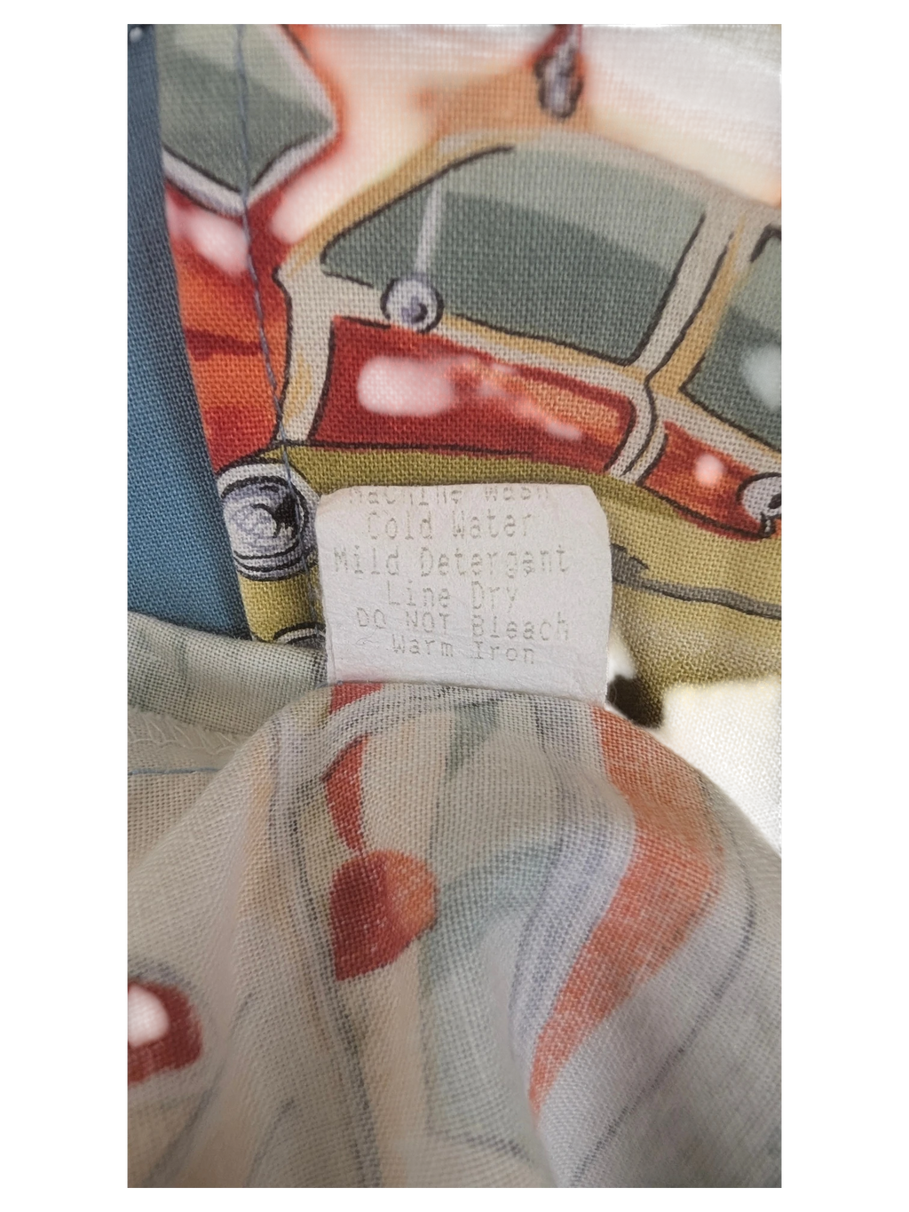 JAKE & IPI vintage RJC Hawaiian shirt care label with washing instructions on colorful retro car print fabric