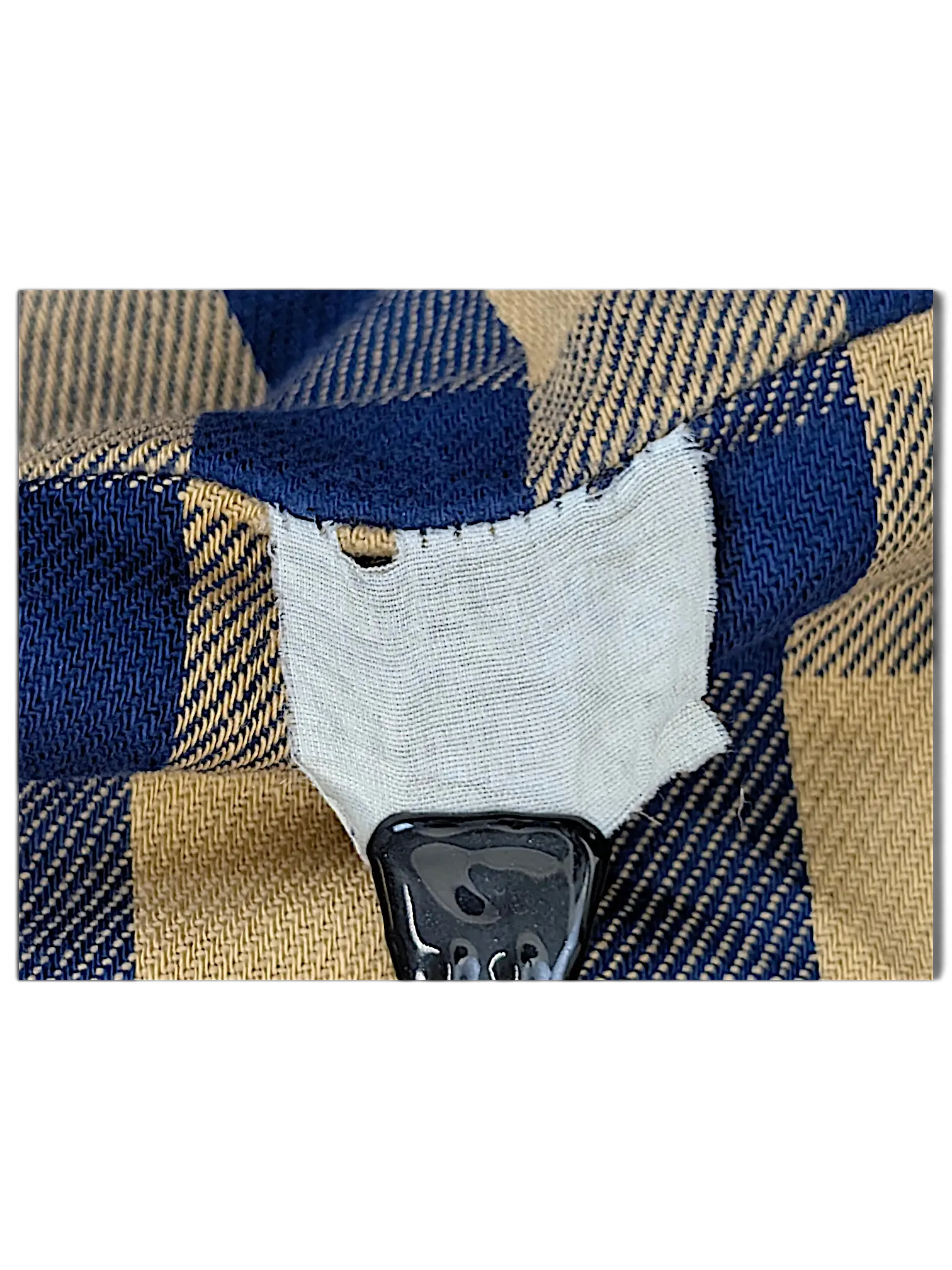 JAKE & IPI vintage blue and tan plaid fabric detail with a white clothing label tag