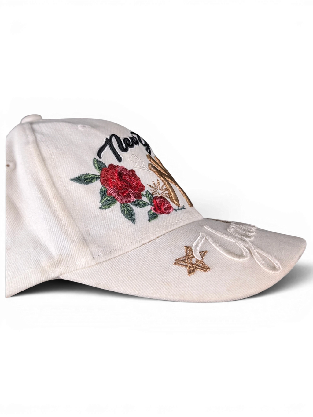 JAKE & IPI white baseball cap featuring New York embroidery, red rose floral details, and gold star accents.