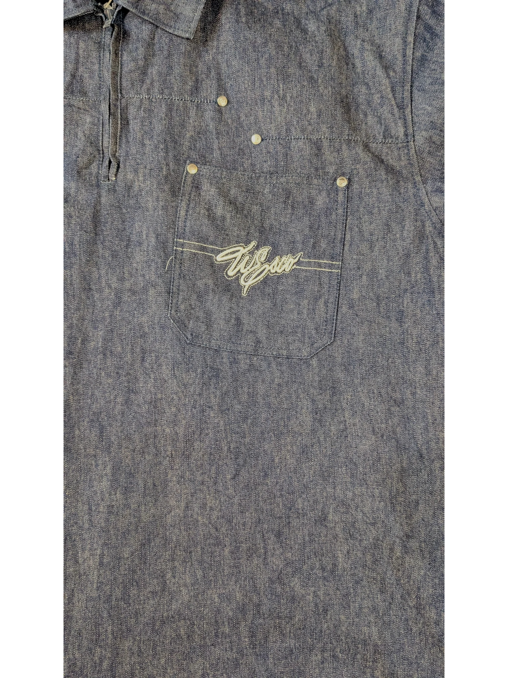 JAKE & IPI Willie Esco denim jacket with embroidered logo on chest pocket. Blue wash, button closure.