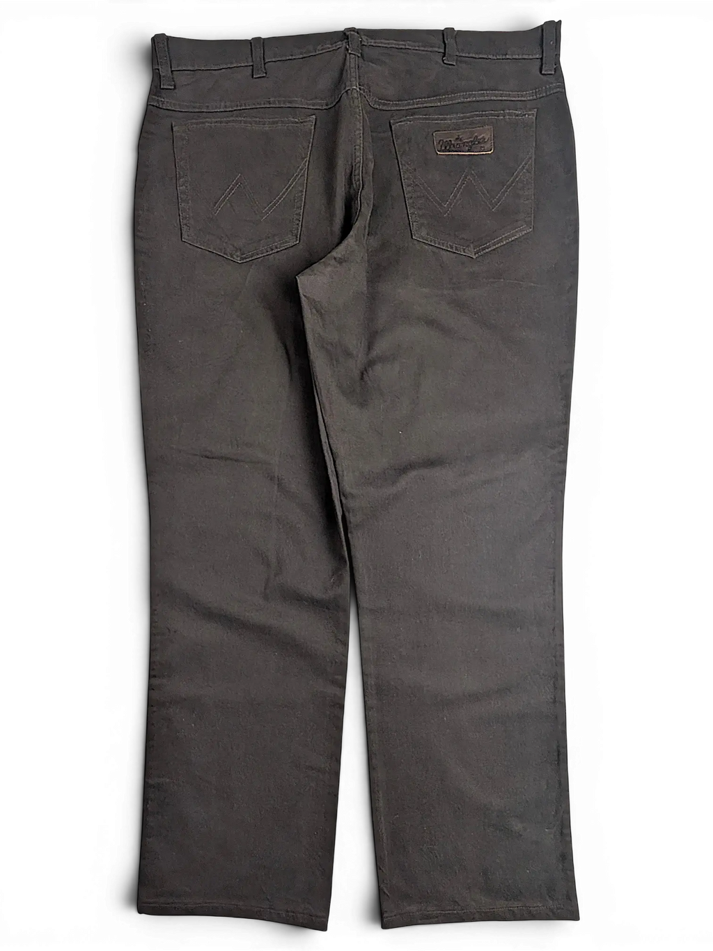 JAKE & IPI Wrangler Texas stretch pants in black with back pockets and signature W stitching on a black background
