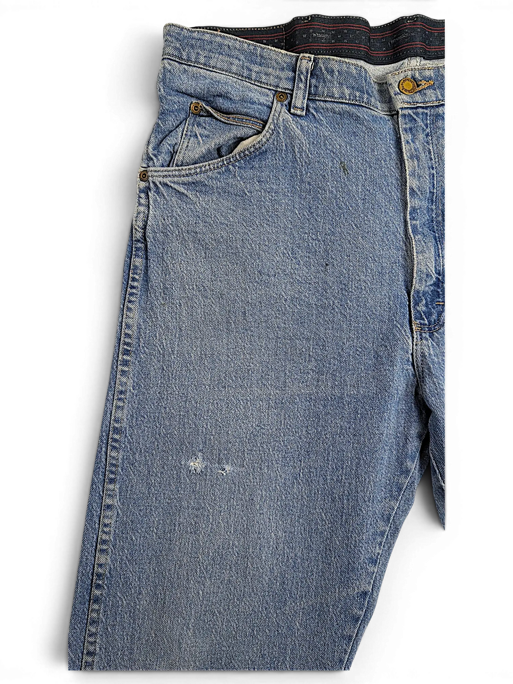 JAKE & IPI Wrangler regular fit blue denim jeans with a distressed finish and classic five-pocket styling