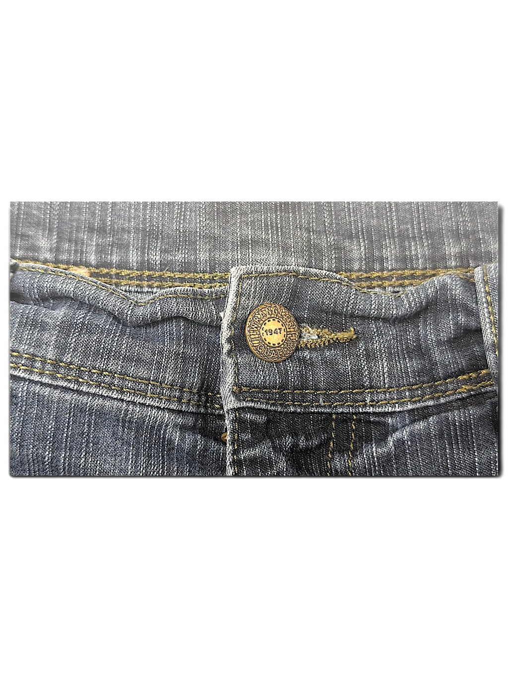 JAKE & IPI Wrangler blue denim jeans featuring a classic brass button with 1947 branding and contrast stitching.