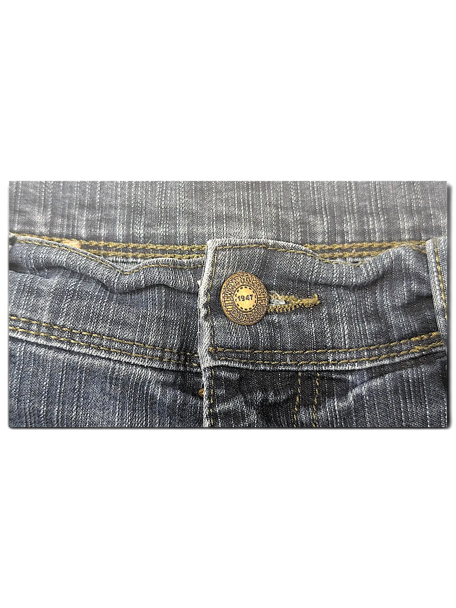 JAKE & IPI Wrangler blue denim jeans featuring a classic brass button with 1947 branding and contrast stitching.