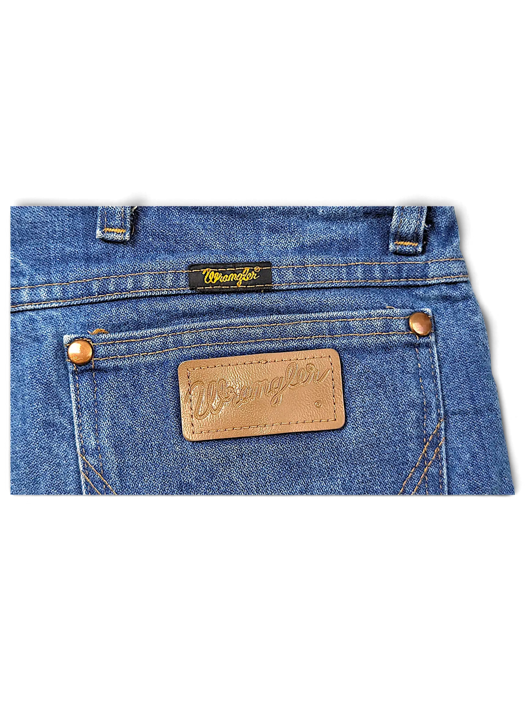 JAKE & IPI Wrangler 936DEN blue denim jeans featuring a brown leather logo patch and copper rivets on the back pocket