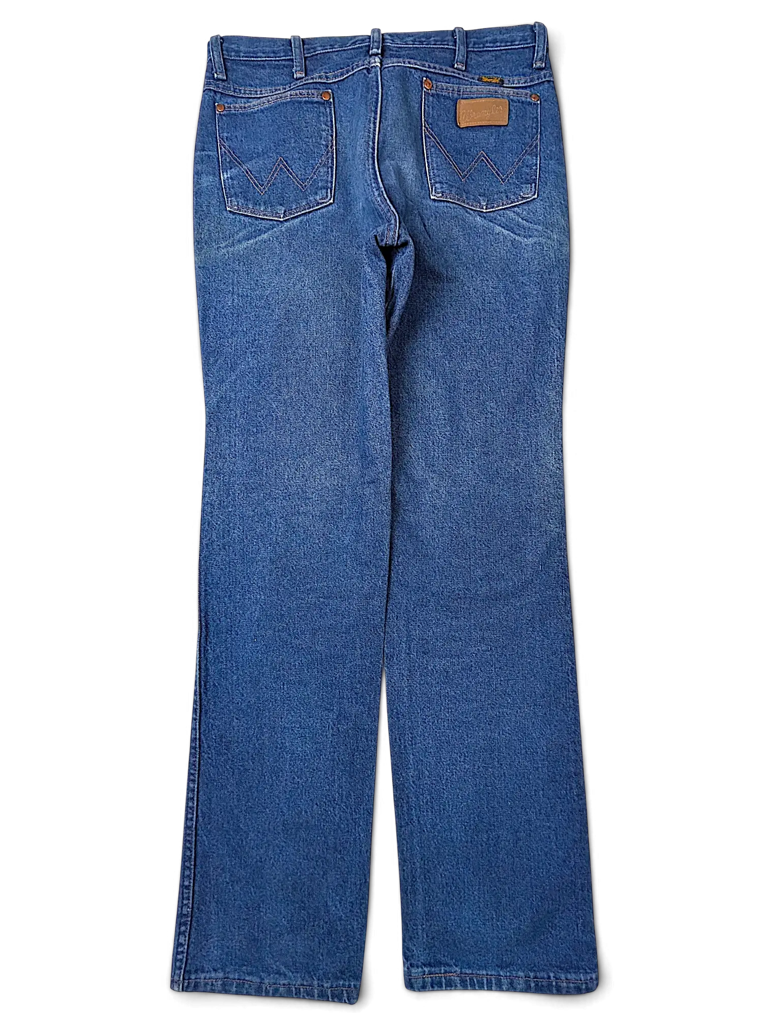 JAKE & IPI Wrangler 936PWD blue denim jeans with back pocket stitching and leather patch, flat lay view.