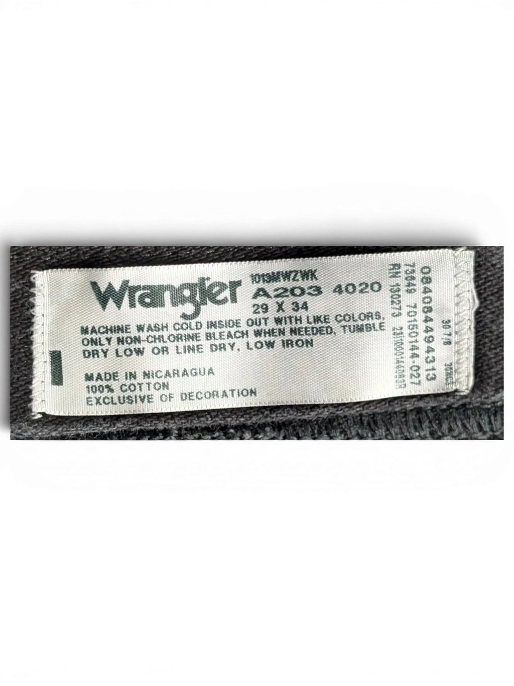 JAKE & IPI Wrangler A203 black denim jeans interior care label showing size 29x34 and 100 percent cotton material