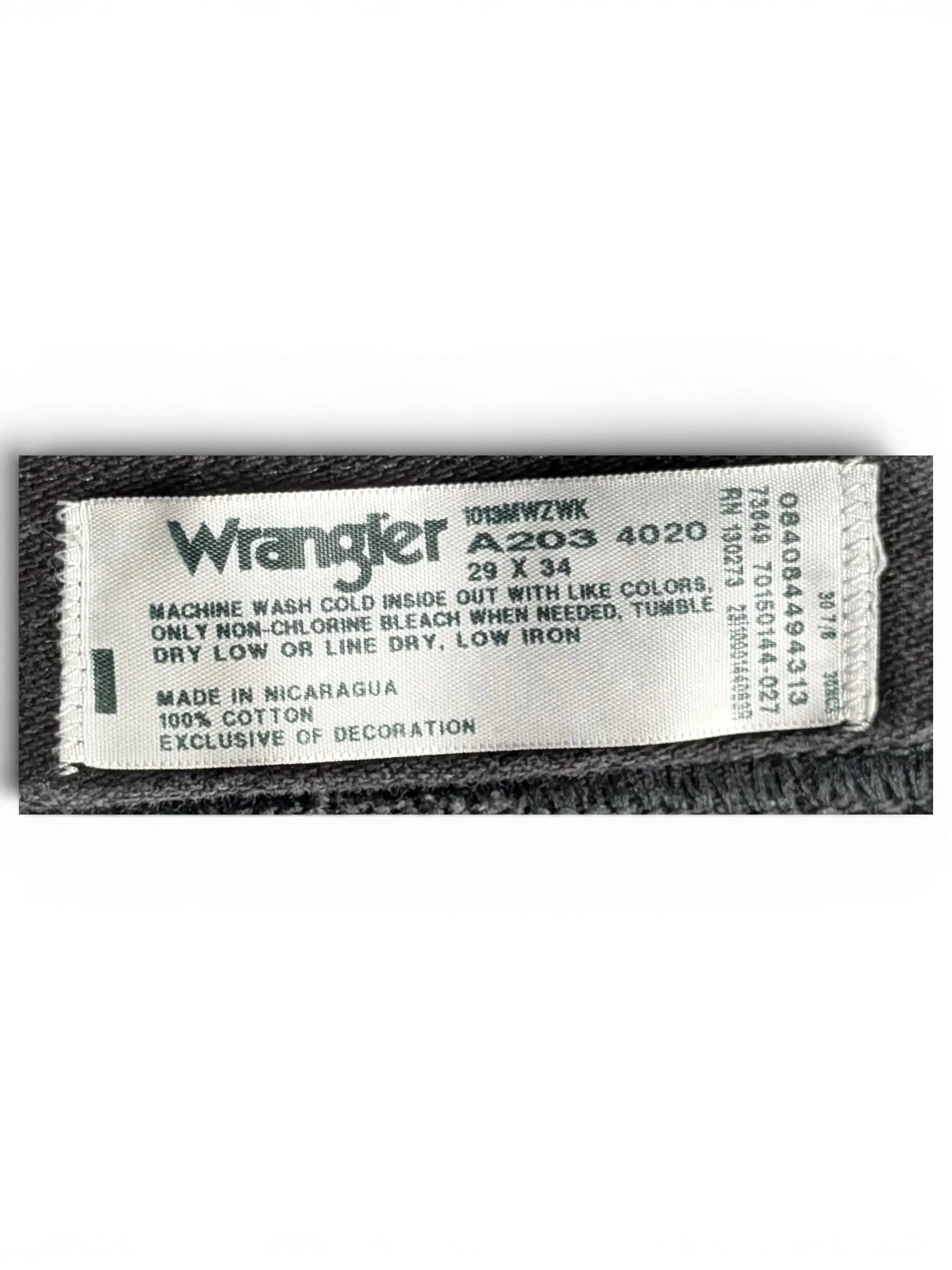 JAKE & IPI Wrangler A203 black denim jeans interior care label showing size 29x34 and 100 percent cotton material