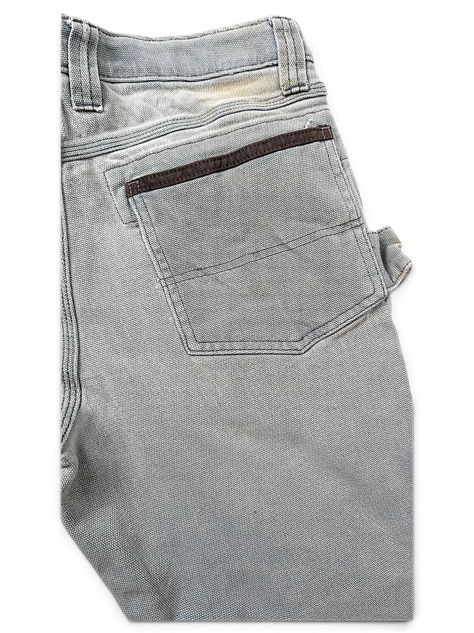 JAKE & IPI grey Wrangler Riggs workwear pants featuring a reinforced back pocket with brown trim and utility loop