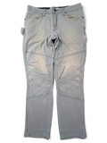JAKE & IPI Wrangler Riggs Workwear pants in faded grey canvas with reinforced knees and utility pockets.