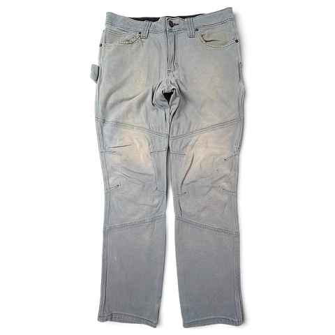 JAKE & IPI Wrangler Riggs Workwear -työhousut, haalistunutta harmaata canvasia, vahvistetut polvet ja hyötytaskut.